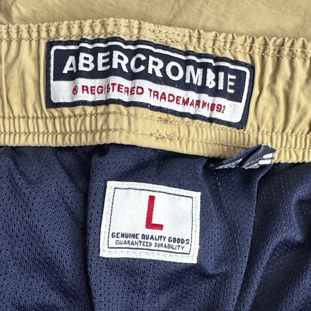Vintage 90’s  Y2K Abercrombie and Fitch tan track pants with white stripes.
